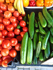 Local farmers markets vegetables showcase with ripe organic tomatoes and cucumbers. Top view. Healthy eating. Vegan food. Agriculture. Agribusiness. Growing and harvesting bio organic vegetables