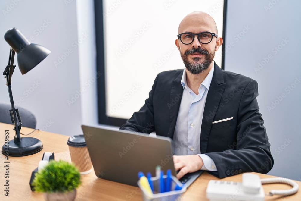 Poster Young bald man business worker using laptop working at office