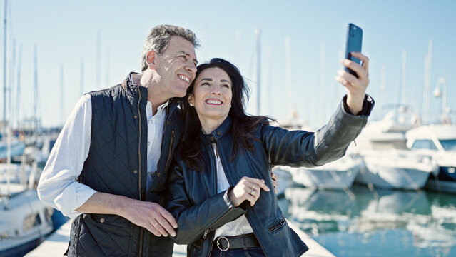 Senior man and woman couple smiling confident make selfie by camera at port