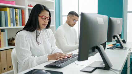 Obraz na płótnie Canvas Man and woman students using computer studying at university classroom