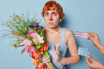 Worried redhead woman has allergy to pollen poses with red watery eyes needs to take some medicine...