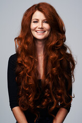 Red hair, happy and portrait of woman in studio for keratin treatment, wellness and haircare on...