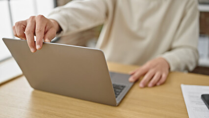 Young caucasian man opening laptop sitting on table at dinning room