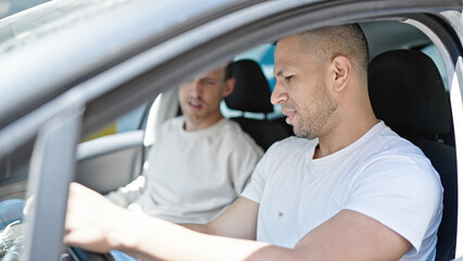 Two men couple driving car at street