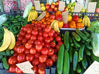 Counter on market with prices. Fresh organic fruits and vegetables displayed for sale in local farmer markets or bazaar. View from above. Veganism. Vegetarianism. Nourishment. Healthy eating