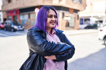 Obraz premium Young beautiful plus size woman standing with arms crossed gesture at street