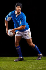 Rugby, dark and man sports athlete pass a ball at night in black studio background training, wellness and fitness. Exercise, workout and professional career of sport male person or player on grass