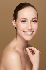 Portrait, smile and woman with beauty, dermatology and grooming against a brown studio background. Face, female person and happy model with cosmetics, organic facial and salon treatment with skincare