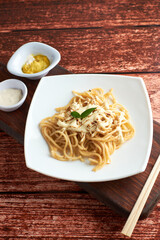 spaghetti with little tomato, using chopsticks