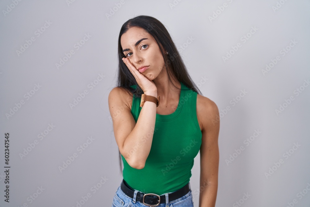 Canvas Prints Young woman standing over isolated background thinking looking tired and bored with depression problems with crossed arms.