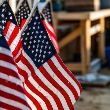 American flags flying with table in background. AI Image