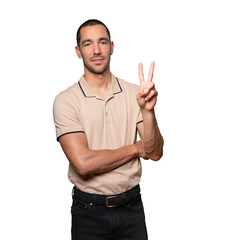 Fototapeta premium Young man making a number two gesture