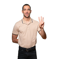Naklejka premium Young man making a number three gesture