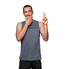 Concerned young man doing a crossed fingers gesture