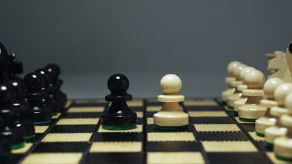 Conflict of interest. Chess pieces on wooden board. Two pawns on the chess board