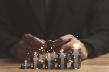 Save money and investment growth concept. Businessman hand holding coin on stack coins with white arrows rising. Financial and business, Management money for retire, tax, bank deposit, accounting