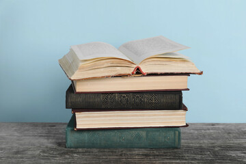 Stack of old books on wooden table