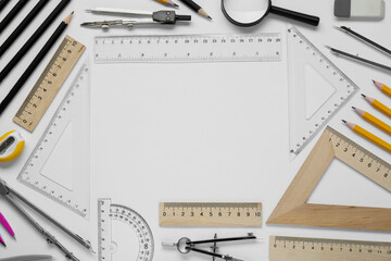 Flat lay composition with different rulers and compass on white background