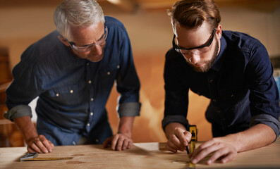 Teamwork, carpenter and apprentice in workshop, wood measurement and designer furniture...