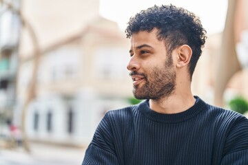 Young arab man smiling confident standing at street