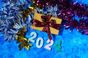 happy new year 2024 background new year holidays card with bright lights, tinsel and gift box on...