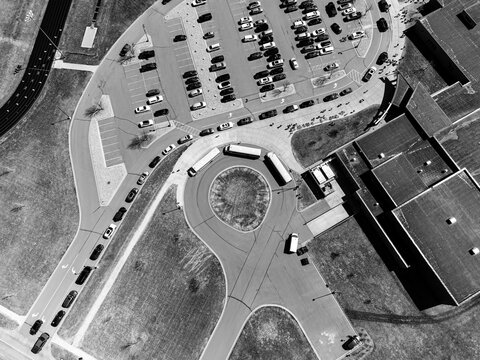Drone overhead aerial view of a school letting out students at the end of the day.