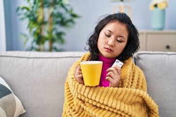 Young chinese woman illness taking pill at home