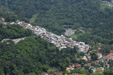 Fototapeta na wymiar Houses in Brazilian favelas among the trees
