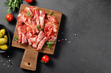 Cured Meat Platter, Coppa with Spices, Italian Antipasto, Appetizer over Dark Background