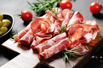 Cured Meat Platter, Coppa with Spices, Italian Antipasto, Appetizer over Dark Background
