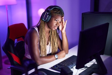 African american woman streamer stressed using computer at gaming room