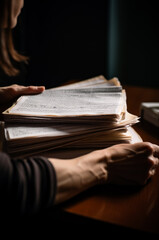 Woman sitting at the desk with a pile of papers in front of her. Paper work concept. Generative AI.