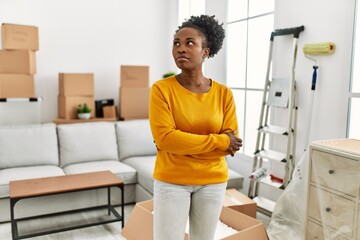 African american woman standing with doubt expression at new home