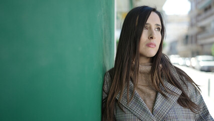 Fototapeta premium Beautiful hispanic woman standing with sad expression at street