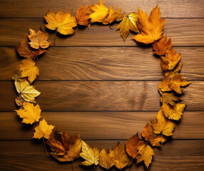 Autumn leaves circle on wooden background with copy space for your text.