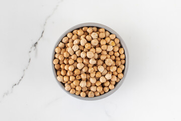 Raw chickpeas in a bowl on a light background. Vegetable protein. Vegetarianism.
