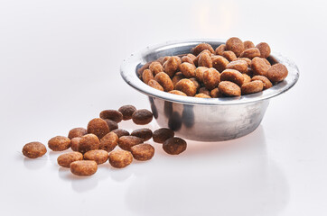  Delicious bowl of dog food balls over isolated white background