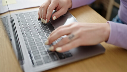 Young beautiful hispanic woman using laptop at office