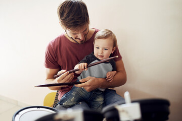 Happy father, baby and child drum lesson with music development and kids learning. Home, happiness...