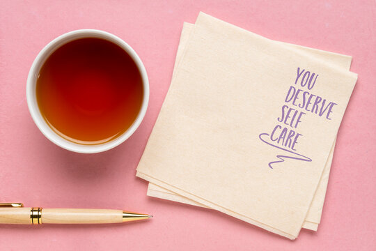 you deserve self care - inspirational reminder on a napkin with tea, mental and physical health and lifestyle concept