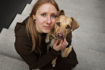 Portrait of beautiful blonde girl with a dog