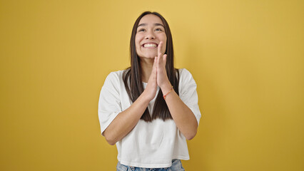 Young beautiful hispanic woman smiling confident clapping applause over isolated yellow background
