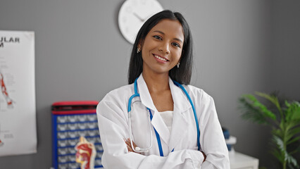 African american woman doctor smiling confident standing with arms crossed gesture at clinic
