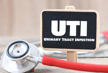 UTI Urinary Tract Infection word on a small chalk board. - obrazy, fototapety, plakaty