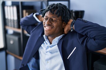 African american man business worker relaxed with hands on head at office