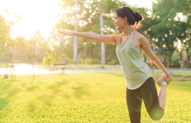 Female jogger. Fit young Asian woman with green sportswear stretching muscle in park before running and enjoying a healthy outdoor. Fitness runner girl in public park. Wellness being concept