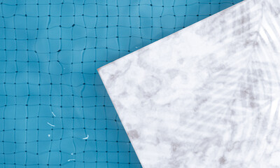 Swimming pool top view background. Summer landscape scene with marble stage. Palm or leaf shadow. Beauty products and cosmetics presentation. Surface blue water. Trendy abstract nature background