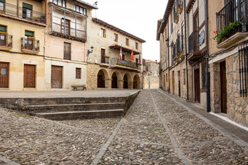 Fototapeta na wymiar a cobbled street with traditional houses in Frías town, Las Merindades, province of Burgos, Castile and León, Spain