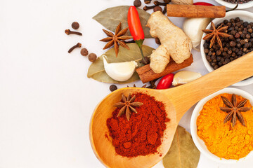 Powder, table top and food spices in studio isolated on white background mock up. Turmeric seasoning, kitchen cooking and variety of leaf herbs in bowls for brunch, healthy diet and paprika in spoon.
