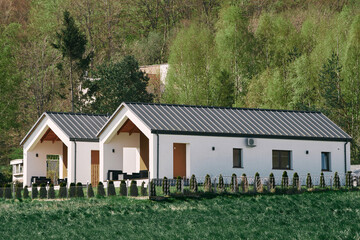 Modern barn house with a stylish exterior and facade. Concept of an eco-friendly house....